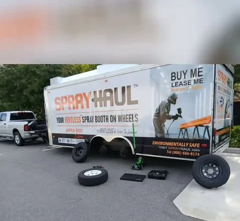 DJR Roadside tire job in progress, wheels and jack beside a trailer
